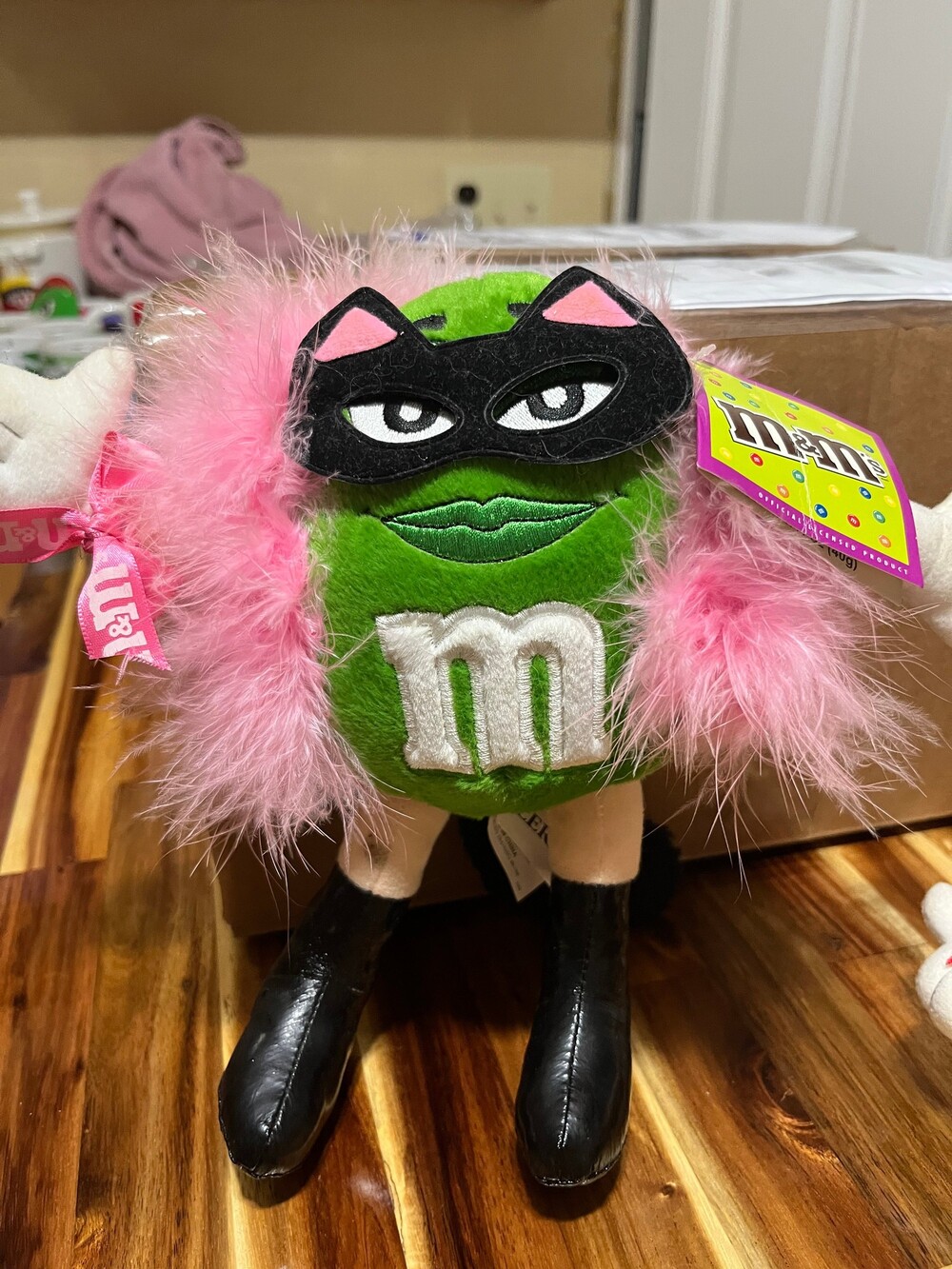M&M's Green Character Plush dressed up as cat women with Pink Feather Boa Plush